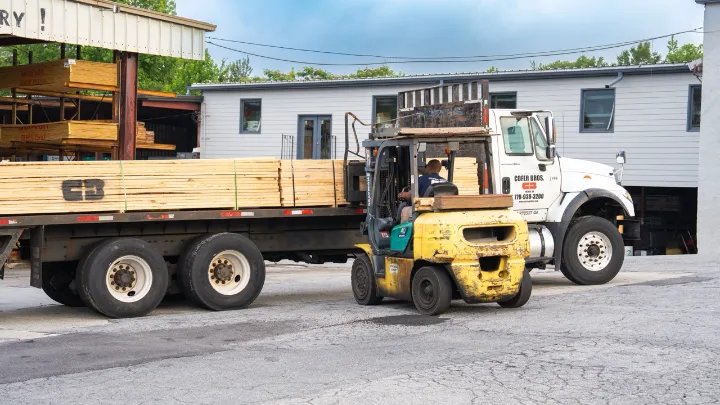 Cofer Brothers forklift loading a lumber truck