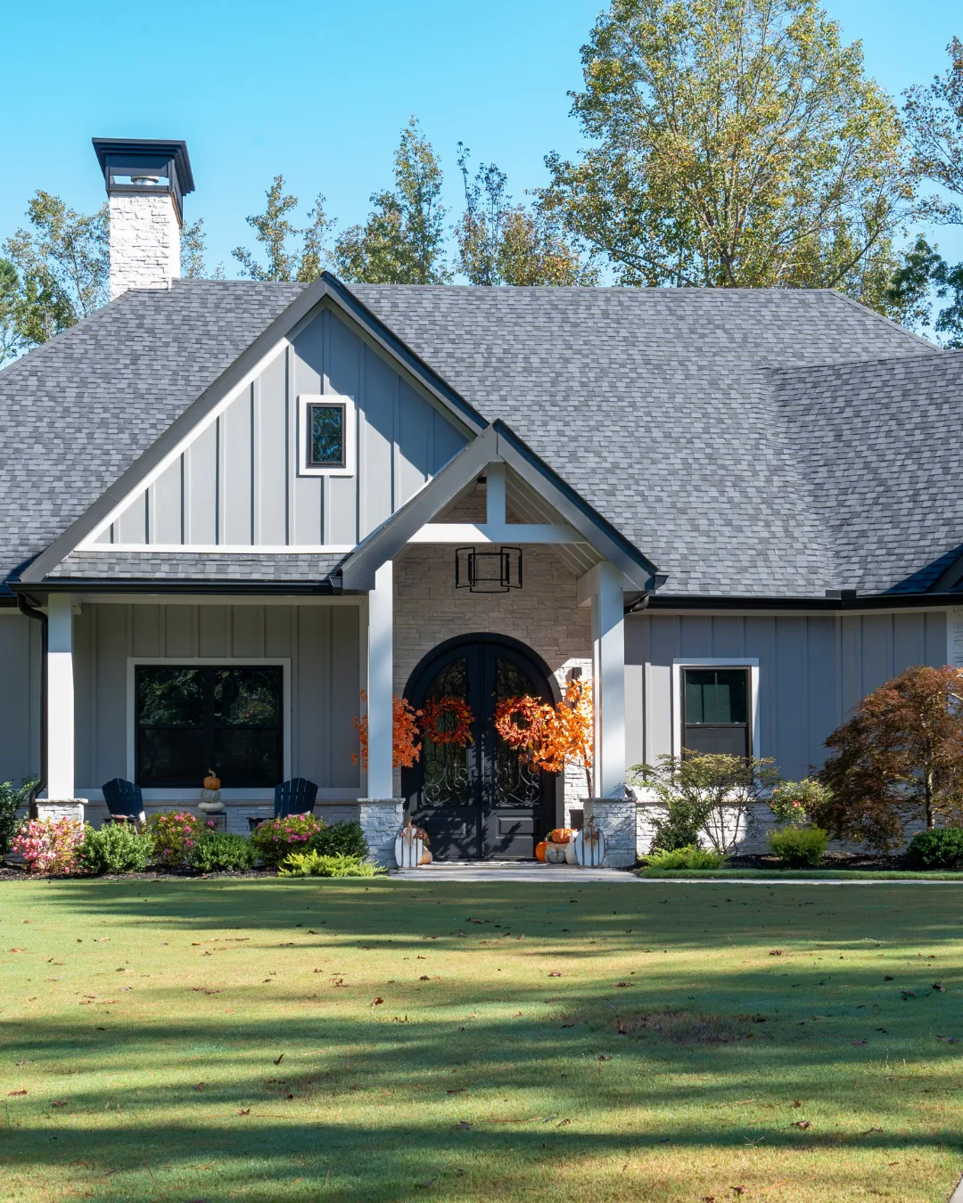 TLC Elite custom home exterior with board-and-batten siding, photographed by Grit Blueprint