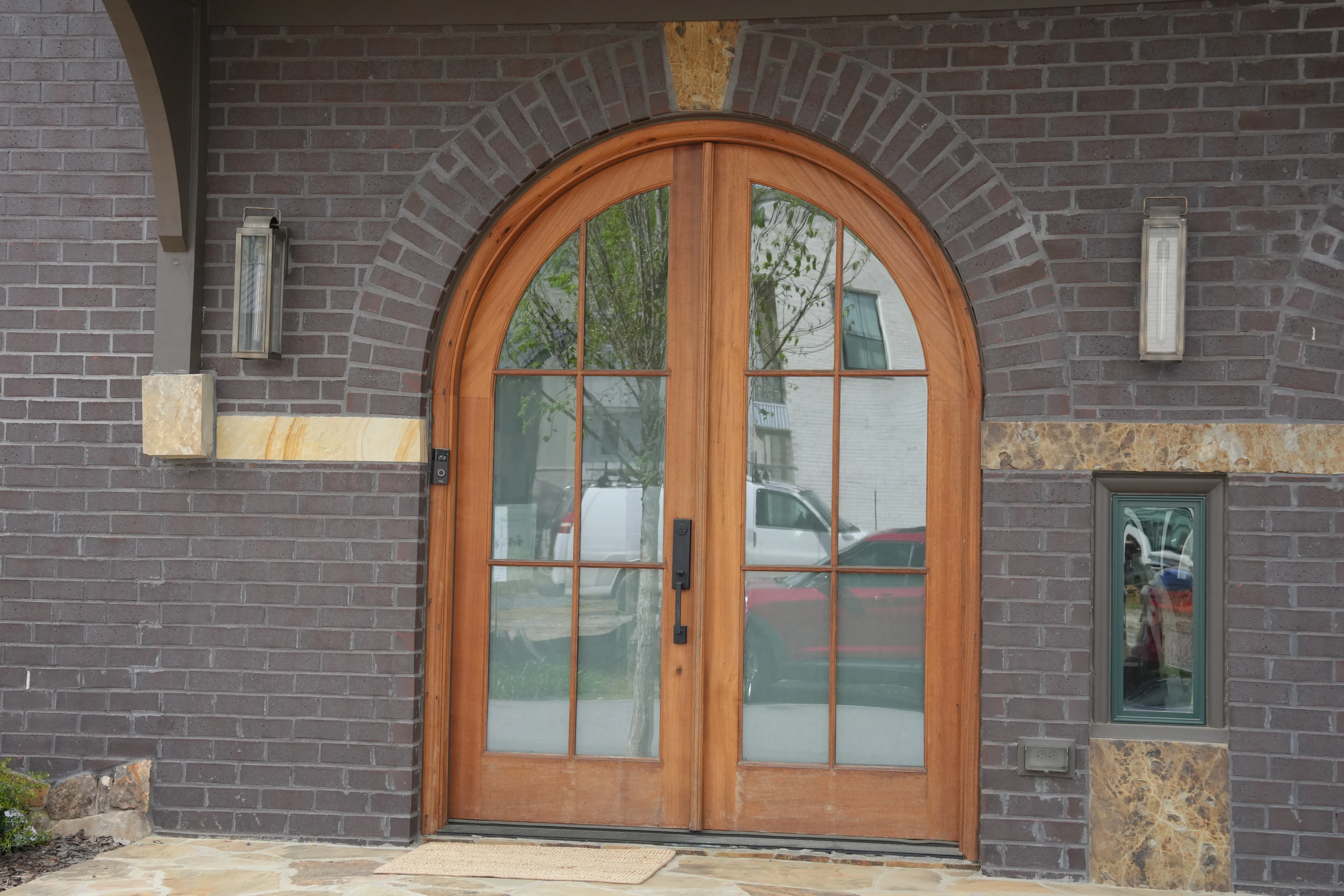 Arched double mahogany entry doors at a Trilith home, photographed by Grit Blueprint