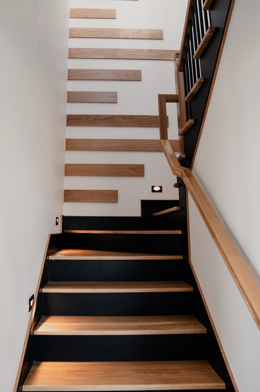 Switchback white-oak staircase with wall-mounted treads and integrated step-lighting, by Coffman Stair Parts, photographed by Grit Blueprint