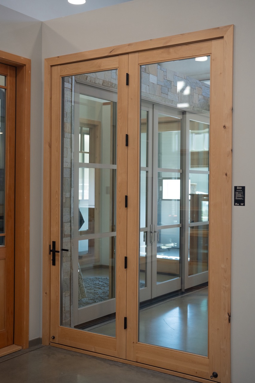 Natural alder wood French doors in a showroom vignette, photographed by Grit Blueprint