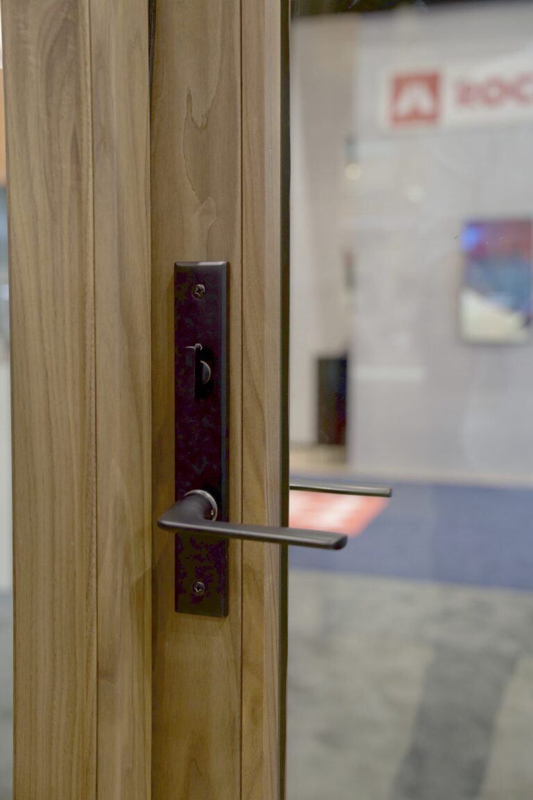 Close view of a door handle and lock on a wood door