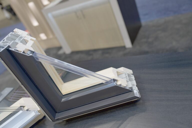 Close view of a window frame corner cutaway with glass