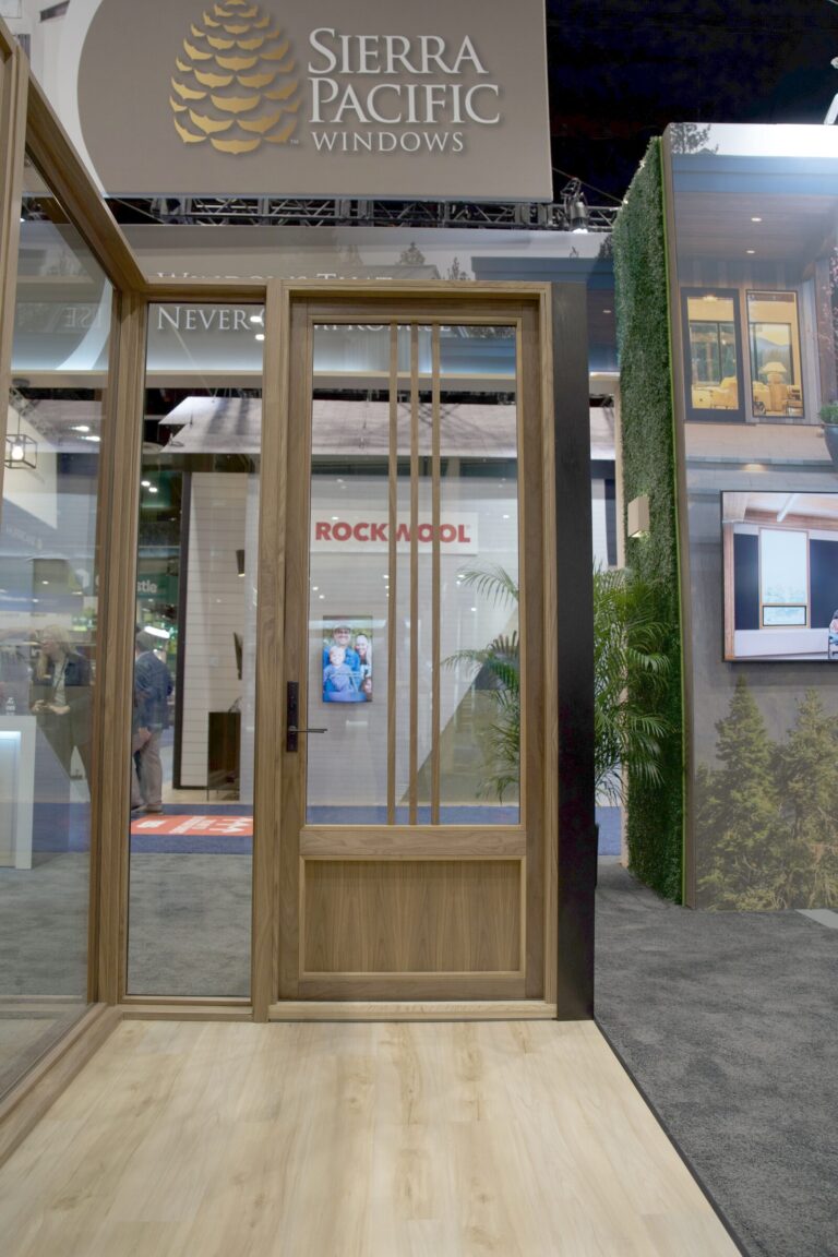 A dark wood glass-panel door under the Sierra Pacific Windows sign