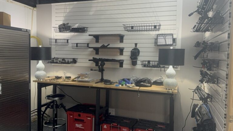 Trusscore slat wall storage between a metal cabinet and a wall of hanging light stands